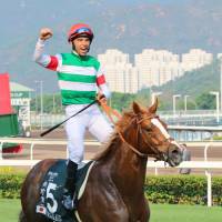Joao Moreira celebrates his win aboard Neorealism at the Audemars Piquet Queen Elizabeth II Cup in Hong Kong on Sunday. | KYODO