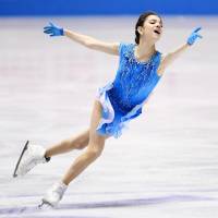 Two-time defending world champion Evgenia Medvedeva dazzles the crowd with a world-record score of 80.05 points in the women\'s short program on Thursday night. | KYODO
