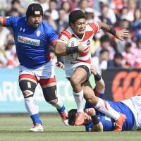 Japan\'s Ryuji Noguchi breaks through a tackle during the Brave Blossoms\' 80-10 win over South Korea on Saturday in the Asia Rugby Championship at Prince Chichibu Memorial Rugby Ground. | KYODO