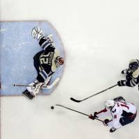 The Capitals’ Justin Williams (bottom) tries to score past the Blue Jackets’ Sergei Bobrovsky as Lauri Korpikoski (right) helps defend the net on Sunday in Columbus, Ohio. Capitals gain breathing room in race for division title