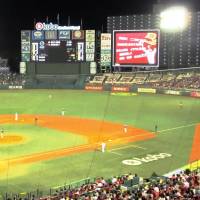 A video screen (with red ad in photo) to the right of the main scoreboard at Kobo Park Miyagi blocks the view of Rakuten Eagles games for residents of the adjacent apartment building. | WAYNE GRACZYK
