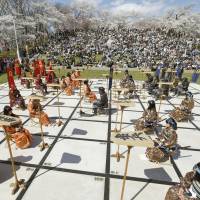 High school students dressed in samurai attire participate as live game pieces on a giant board during a professional game of shogi (Japanese chess) held in Tendo, Yamagata Prefecture, on Saturday. | KYODO