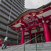 The Narukoten Shrine stands next to a high-rise residential building in Tokyo. Temples and shrines occupy some of the best buildable spaces in the nation’s jam-packed cities. In financial straits, shrines turn to luxury property development