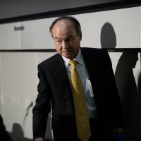 Masayoshi Son, chairman and chief executive officer of SoftBank, leaves a news conference at the Tokyo Stock Exchange in Tokyo on May 10. | BLOOMBERG