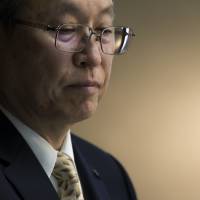 Toshiba President and CEO Satoshi Tsunakawa attends a news conference in Tokyo on Monday. The government urged the firm and its partner, Western Digital, to cooperate amid an escalating dispute. | BLOOMBERG