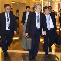 Keiichi Katakami (left), Japan’s chief negotiator for the Trans-Pacific Partnership talks, heads to a meeting with his counterparts in Hanoi on Saturday. Led by Japan, Pacific Rim nations agree to pursue revival of TPP