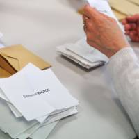 A polling official counts the ballots Sunday in Quimper, western of France during the second round of French presidential election. In record rate, third of French voters spoiled ballots or abstained