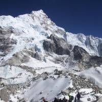 Trekkers are seen walking toward Everest base camp in  Nepal in this March 2015 file photo. A young Indian climber who summited the mountain went missing Saturday on his way down. | AP