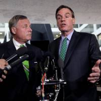 Senate Intelligence Committee Chairman Richard Burr (left) and ranking member Sen. Mark Warner (right) speak about former White House national security adviser Michael Flynn following a Senate Select Committee on Intelligence briefing on Capitol Hill in Washington Tuesday. | REUTERS