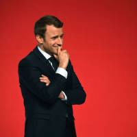 Presidential candidate Emmanuel Macron smiles during a speech at the Angerlarde hall in Chatellerault, western France, on April 28. France's new president banks on de Gaulle's 'majority amplifier' to govern