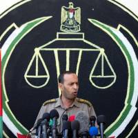 The head of the military court, Nasser Suleiman, speaks to the press in Gaza City on Sunday. A court in the Gaza Strip sentenced three men to death over the assassination of a Hamas military commander that the Islamist movement accused Israel of masterminding. Hamas condemns three Palestinians over commander's killing allegedly ordered by Israel