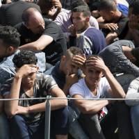 Migrants are detained May 10 at Abosetta base in Tripoli. | AP