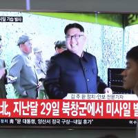 A man passes by a TV news program showing a file image of North Korean leader Kim Jong Un, at the Seoul Railway Station in Seoul Sunday. North Korea on Sunday fired a midrange ballistic missile, U.S. and South Korean officials said, in the latest weapons test for a country speeding up its development of nuclear weapons and missiles. The letters read: \"North Korea launched a missile on April 29.\" | AP