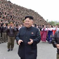 North Korean leader Kim Jong Un laughs with Gen. Ri Pyong Chol at a photo session in Pyongyang on April 17. | KCNA / VIA REUTERS