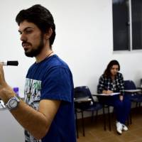 Syrian refugee Adel Bakkour (left) teaches Arabic in Rio de Janeiro on April 20. The Brazilian NGO Abraco Cultural (Cultural Embrace) hires refugees to teach their own language to local people. Refugees in Brazil find new life as language teachers