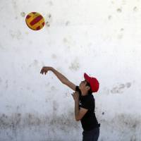 An unaccompanied refugee plays in the Krnjaca refugee center near Belgrade on Thursday. | AP