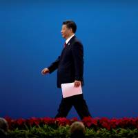 Chinese President Xi Jinping exits the stage after addressing the \"Belt and Road\" globalization initiative in Beijing on Sunday. | REUTERS