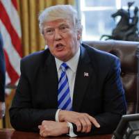 President Donald Trump speaks in the Oval Office of the White House in Washington in March. Trump has been handing out his cellphone number to world leaders and urging them to call him directly, an unusual invitation that breaks diplomatic protocol and is raising concerns about the security and secrecy of the U.S. commander in chief’s communications. Trump urging world leaders to call his personal cellphone, raises security concerns