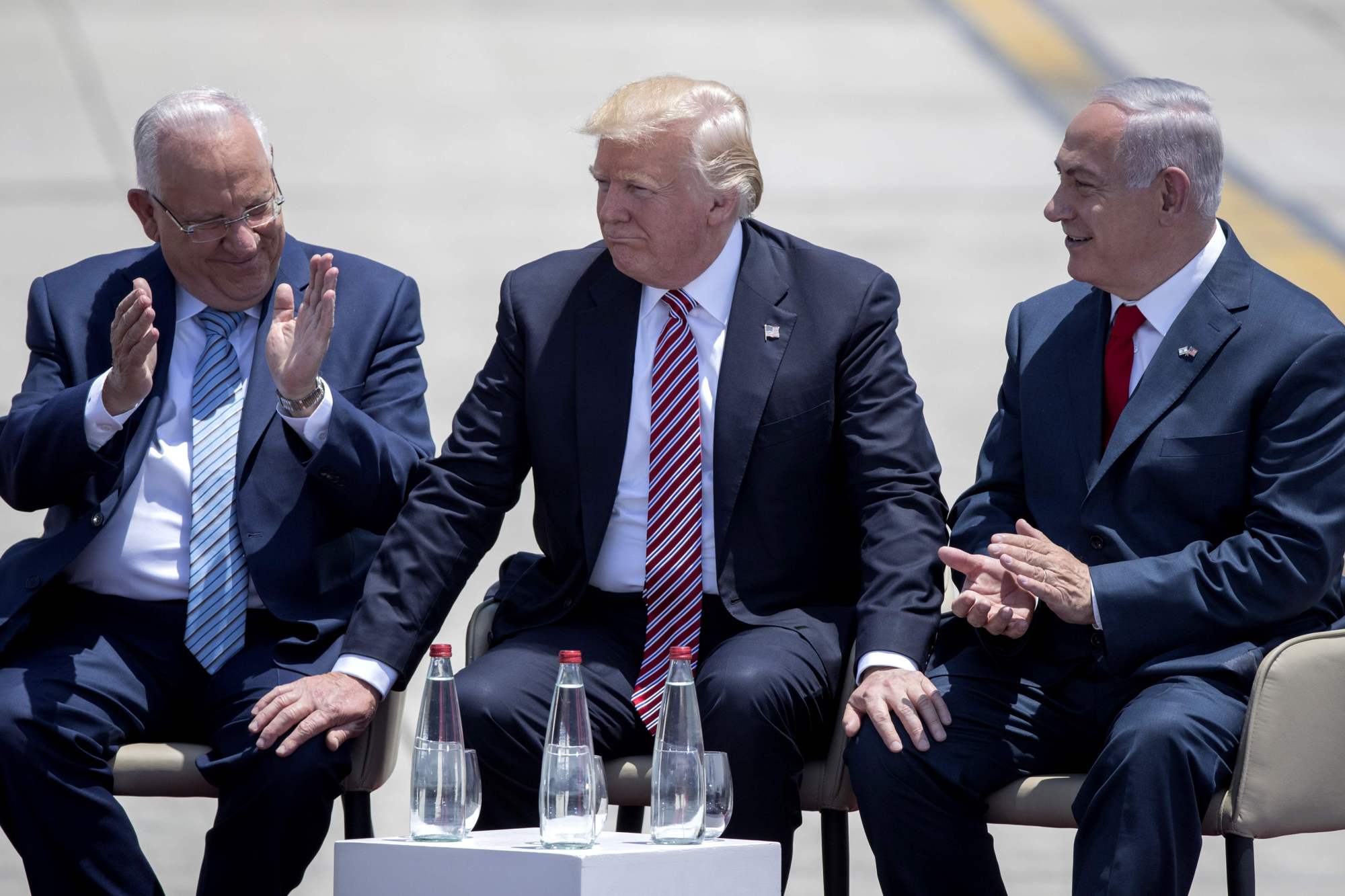 U.S. President Donald Trump and Israeli President Reuven Rivlin (left) and Israeli Prime Minister Benjamin Netanyahu (right) speak upon Trump's arrival at Ben Gurion International Airport in Tel Aviv on Monday as part of his first trip overseas. | AFP-JIJI