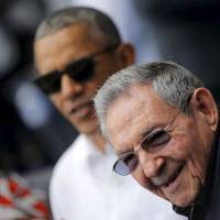 Then-U.S. President Barack Obama and Cuban leader Raul Castro arrive at Estadio Latinoamericano in Havana to attend a baseball game on March 22, 2016. | REUTERS