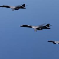 A pair of U.S. B-1B strategic bombers conduct joint drills with Air Self-Defense Force F-15s in airspace over the Kyushu region Monday. | JAPANESE DEFENSE MINISTRY