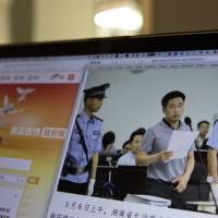 A photo described as showing the trial of human rights lawyer Xie Yang is displayed on a computer in Beijing on Monday. Chinese court says prominent rights lawyer admits to crimes
