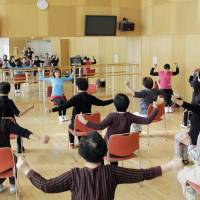 A provided photo shows elderly people exercising along with music in Kiho, Mie Prefecture. Mie University researchers have found that exercising combined with music is effective in preventing dementia from worsening. | KYODO