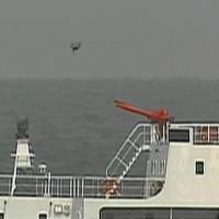 What appears to be a drone flies above one of the four China Coast Guard vessels Thursday morning after they entered Japanese waters around the Senkaku Islands in the East China Sea. | JAPAN COAST GUARD / VIA KYODO