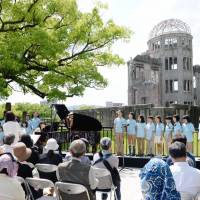 People perform during a concert near the Atomic Bomb Dome in Hiroshima on Saturday to mark the anniversary of a visit by then U.S. President Barack Obama. Concert at A-bomb dome celebrates Obama's 2016 visit to Hiroshima