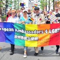 Marchers carry the rainbow flag during the annual Tokyo Rainbow Pride event held in the Shibuya district of central Tokyo on Sunday. This year’s theme was “change,” a call to respect everyone as individuals, regardless of their sexuality. | YOSHIAKI MIURA