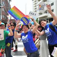 Marchers carry the rainbow flag during the annual Tokyo Rainbow Pride event held in the Shibuya district of central Tokyo on Sunday. This year’s theme was “change,” a call to respect everyone as individuals, regardless of their sexuality. | YOSHIAKI MIURA