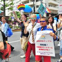 Marchers carry the rainbow flag during the annual Tokyo Rainbow Pride event held in the Shibuya district of central Tokyo on Sunday. This year’s theme was “change,” a call to respect everyone as individuals, regardless of their sexuality. | YOSHIAKI MIURA