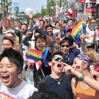 Marchers carry the rainbow flag during the annual Tokyo Rainbow Pride event held in the Shibuya district of central Tokyo on Sunday. This year’s theme was “change,” a call to respect everyone as individuals, regardless of their sexuality. | YOSHIAKI MIURA