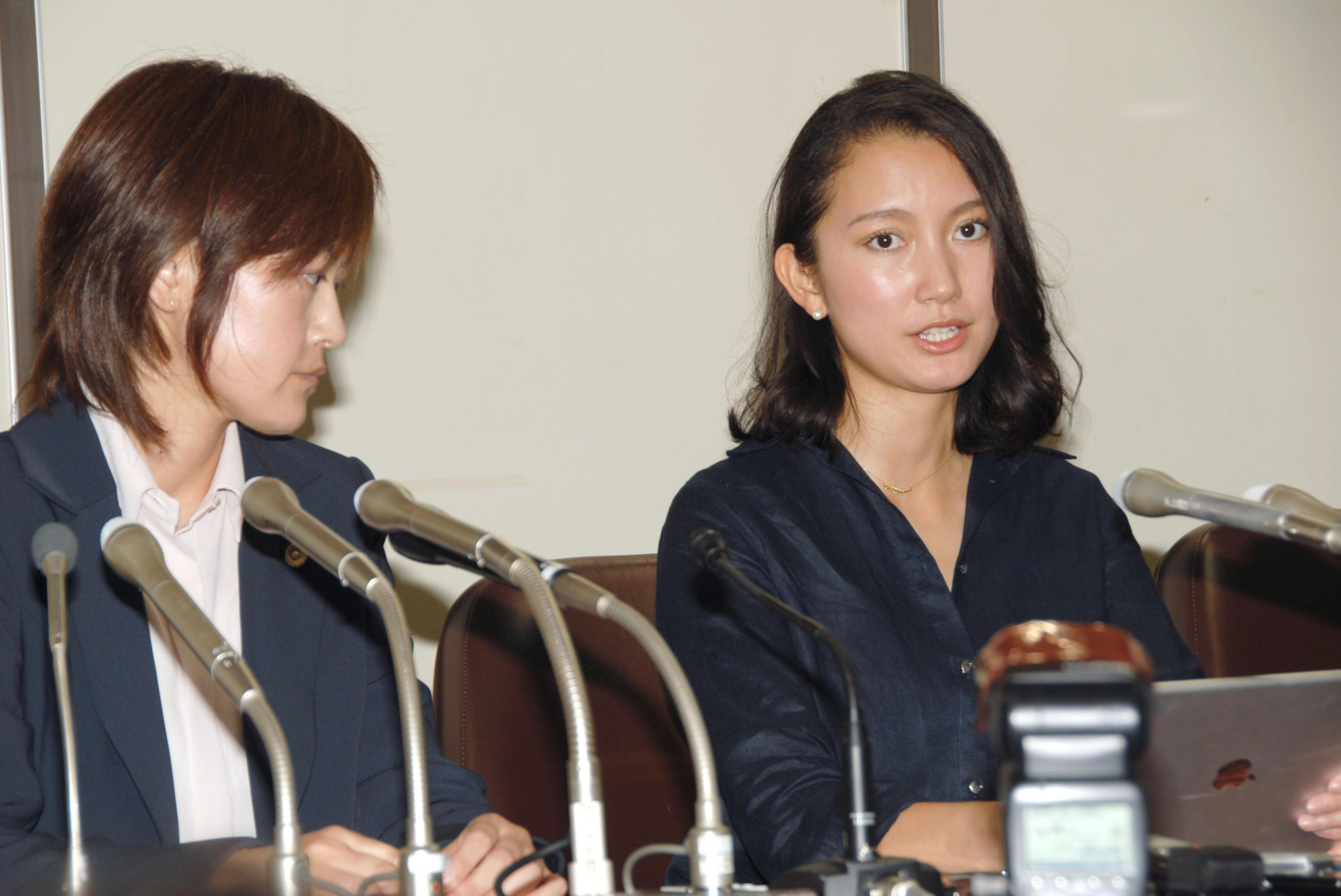 A woman who gave her name only as Shiori (right) speaks at a news conference in Tokyo on Monday about her allegation that a high-profile journalist raped her in 2015. | KYODO
