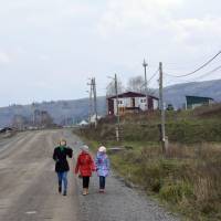 Russians walk in a street on Shikotan, one of the disputed islands off Hokkaido where Japan and Russia are looking to launch joint economic ventures. | KYODO