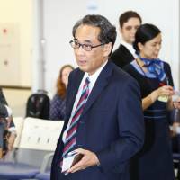Eiichi Hasegawa, a special adviser to Prime Minister Shinzo Abe, leaves Narita International Airport for Sakhalin on Tuesday. | KYODO