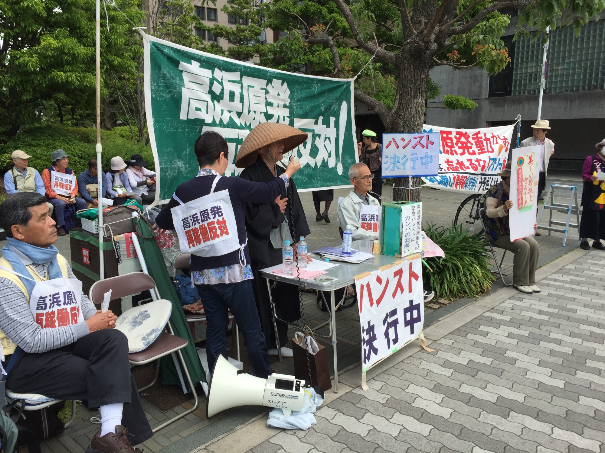 Activists gather in front of Kansai Electric Power Co.'s headquarters in Osaka on Wednesday to protest the restart of the Takahama No. 4 reactor, which is back online after more than 14 months. | ERIC JOHNSTON