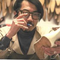Hidetaka Fukaya works on a shoe in his workshop in Florence, Italy. Shoemaker Hidetaka Fukaya models creations on feline elegance