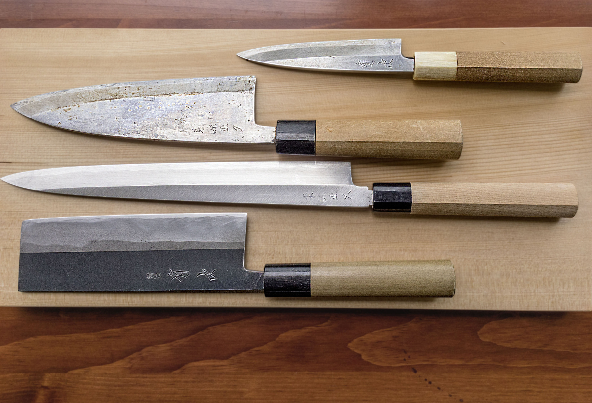 An assortment of Japanese kitchen knives, from top to bottom: ajikiri; deba; yanagiba and nakiri. | MAKIKO ITOH