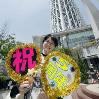 Five years old: A visitor celebrates Tokyo Skytree\'s fifth anniversary in front of the tower in Sumida Ward. | KYODO