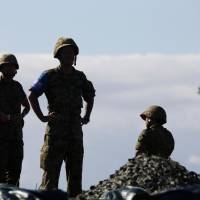 Members of the Ground Self-Defense Force take part in a live fire exercise in August. Prime Minister Shinzo Abe is aiming to have the Constitution’s Article 9 amended by 2020 to clarify the legal status of the Self-Defense Forces. A crisis of constitutional politics