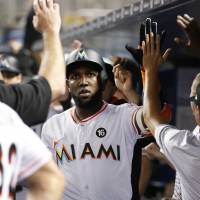 Marcell Ozuna and the Marlins are keeping late pitcher Jose Fernandez in their hearts as they play this season. | AP