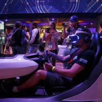 An attendee play a VR game in the Sony Playstation preview area prior to the company’s news conference to kick off their products at E3 2017 in Los Angeles on Monday Sony fires at Xbox with arsenal of big PS4 games