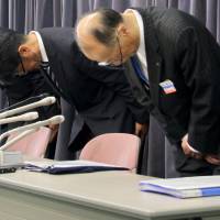 Vanilla Air officials bow in apology at a news conference Monday in Tokyo for allowing 10 passengers on a flight from Hong Kong to enter Japan without going through immigration due to misguidance at Narita International Airport on Sunday night. | KYODO