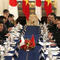 Prime Minister Shinzo Abe speaks as his Vietnamese counterpart, Nguyen Xuan Phuc (right), listens during their summit meeting Tuesday in Tokyo. Japan, Vietnam leaders vow unity in bid to bring TPP into force