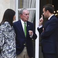 Former New York Mayor Michael Bloomberg talks with French President Emmanuel Macron and Paris Mayor Anne Hidalgo at the Elysee Palace in Paris on Friday. Bloomberg delivers U.S. pledge to continue Paris climate goals to UN