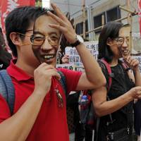 Protesters wear masks of jailed Chinese Nobel laureate Liu Xiaobo during a demonstration outside the Chinese liaison office in Hong Kong on Tuesday. U.S. hopes to see Chinese activist Liu treated for cancer 'elsewhere'