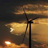 A turbine at the Lost Creek Wind Farm is silhouetted against the setting sun on Thursday near King City, Missouri. | AP