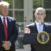 U.S. President Donald Trump listens while Environmental Protection Agency Administrator Scott Pruitt speaks after announcing the U.S. will withdraw from the Paris accord, in the Rose Garden of the White House Thursday in Washington. The EPA plans massive staff cuts, an internal memo reportedly indicates. | AFP-JIJI