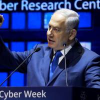 Israeli Prime Minister Benjamin Netanyahu speaks at a cybersecurity conference at Tel Aviv University in Israel on June 26. | REUTERS